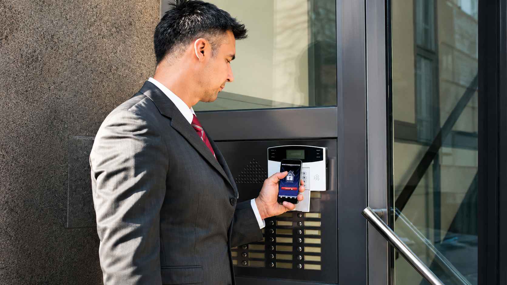 Commercial locksmith security solutions with a professional using smart access control technology for secure business entry points.